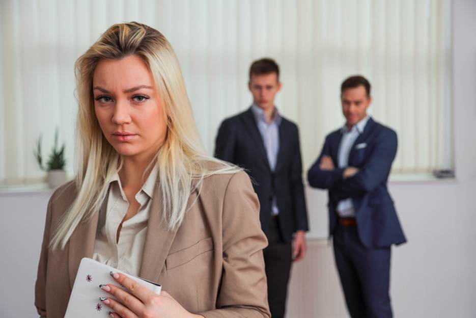 Men judging female coworker - Sexual Discrimination